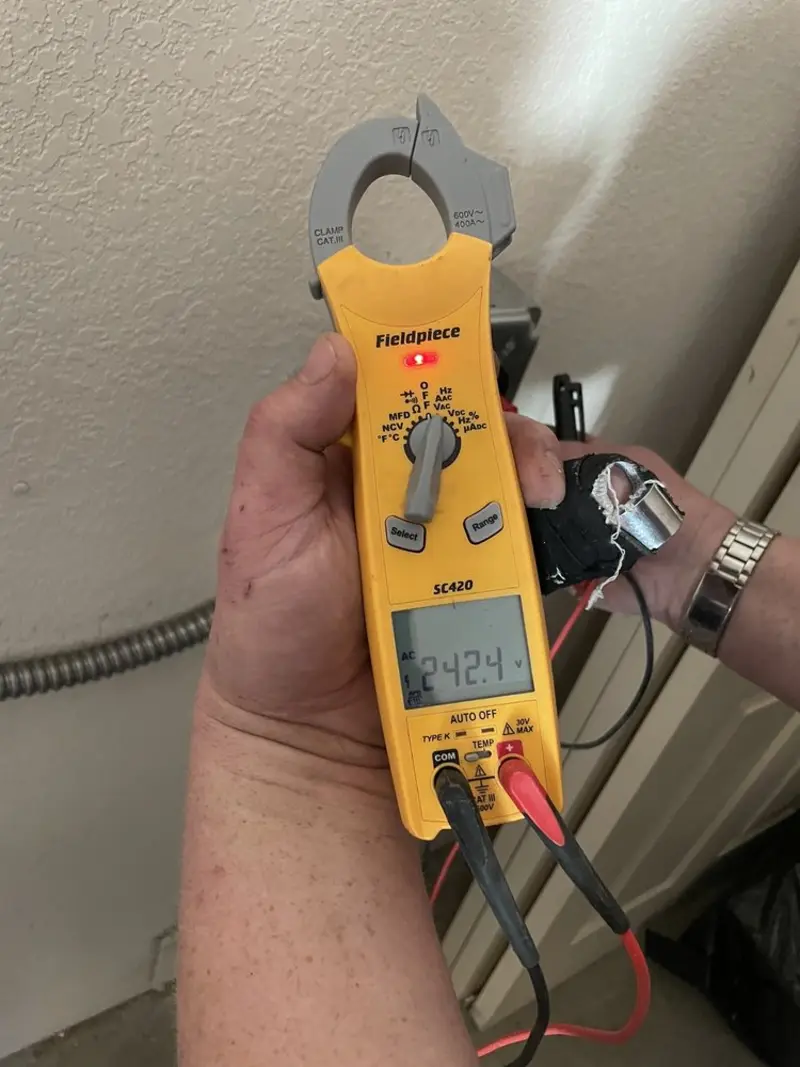 Voltage testing with clamp meter during Electrical Installation Services in Ira